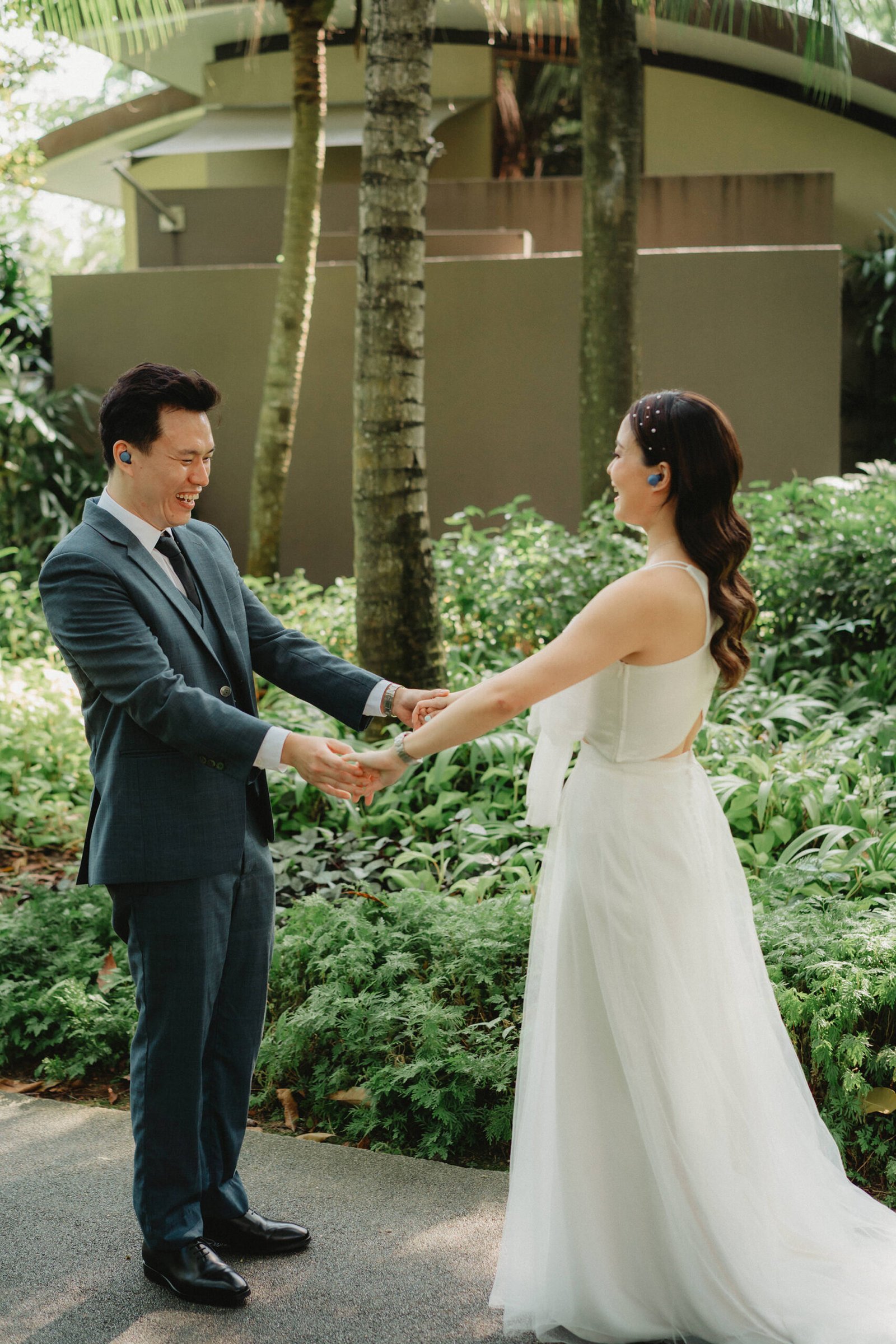 Couple holding hands at Capella Singapore wedding, Han + Ming