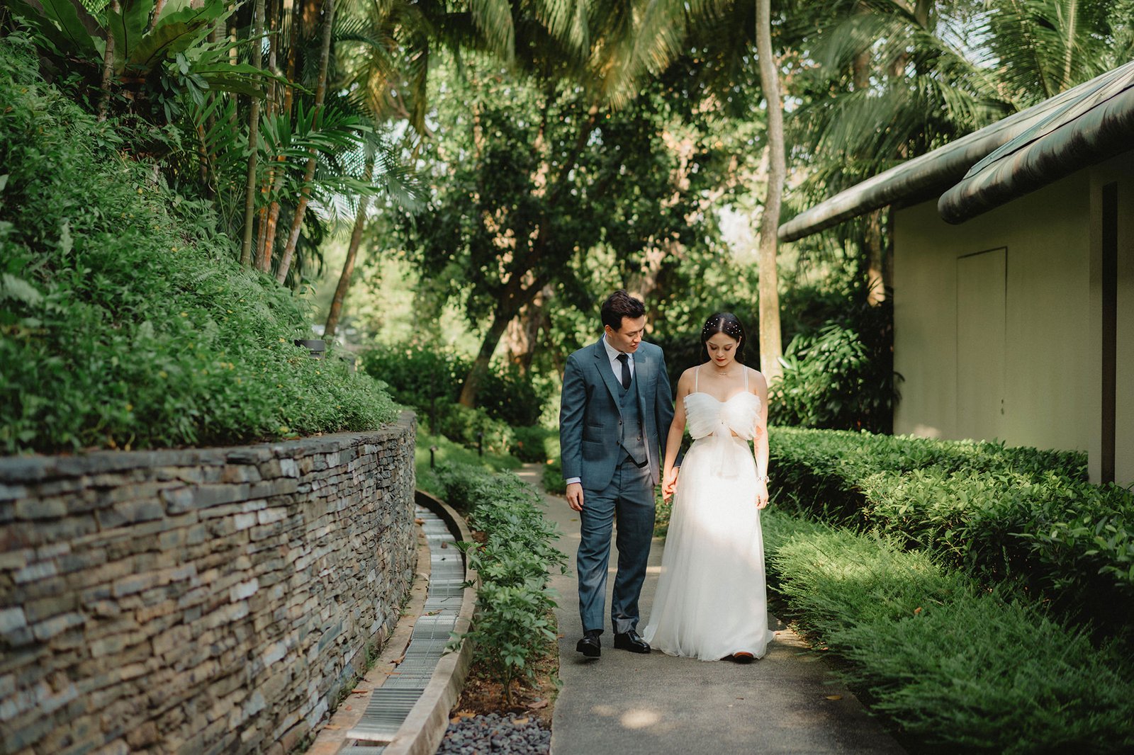 Couple holding hands at Capella Singapore wedding