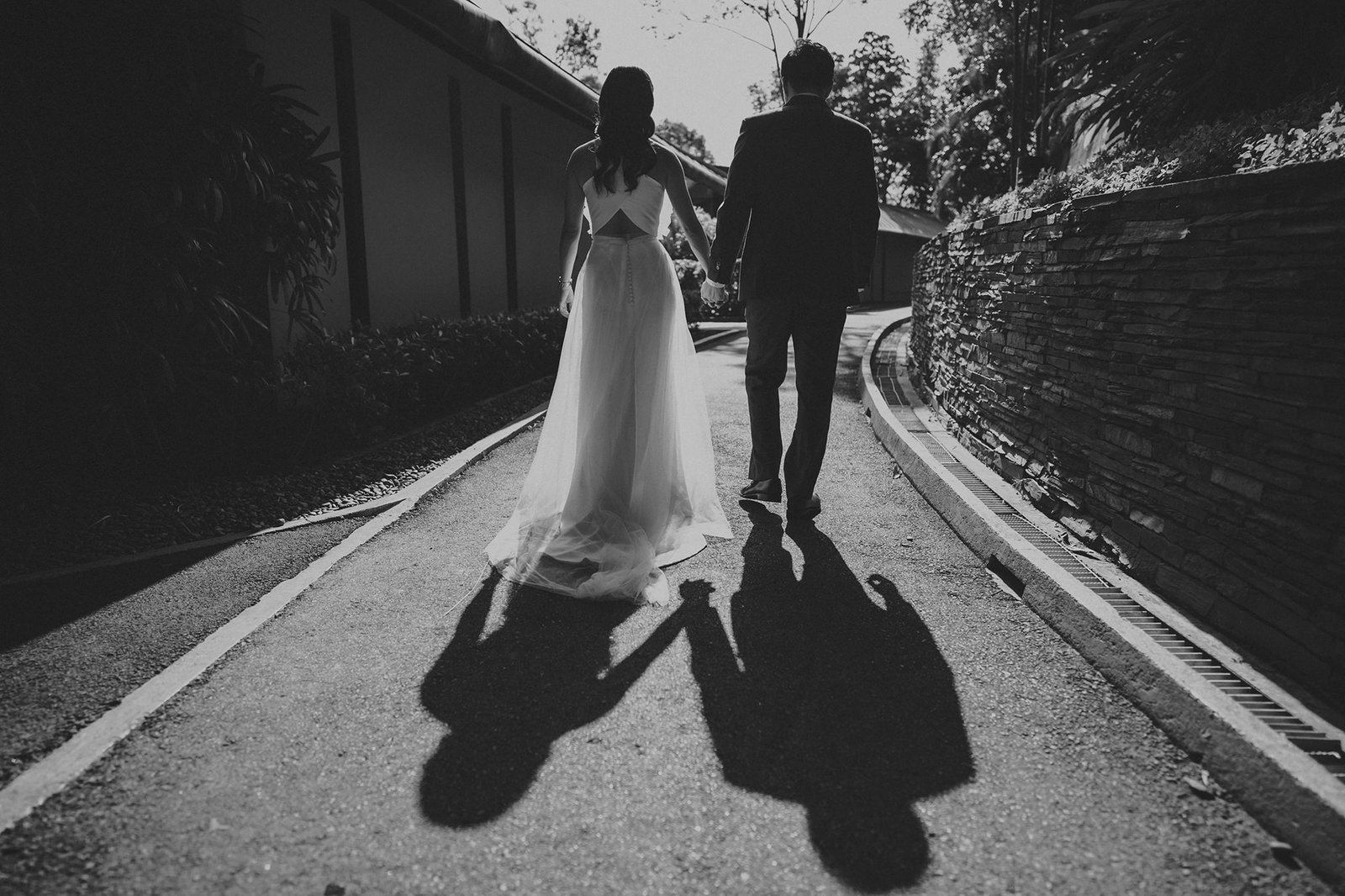 Bride and groom holding hands at Capella Singapore wedding