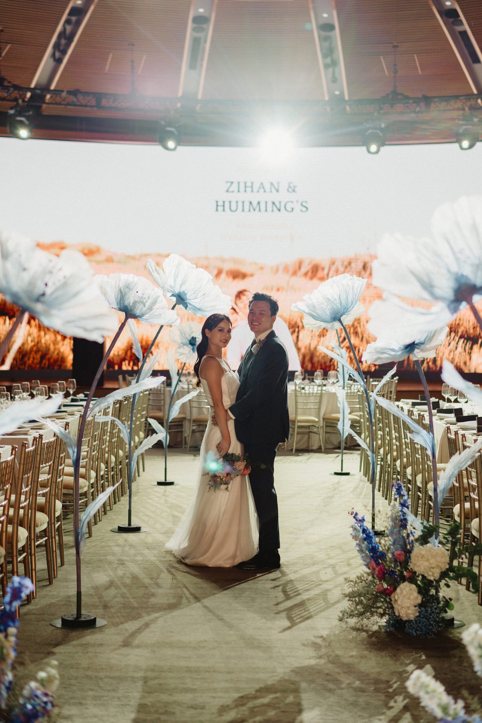 Zihan & Huiming's wedding at Capella Singapore, featuring a couple amidst floral decor.