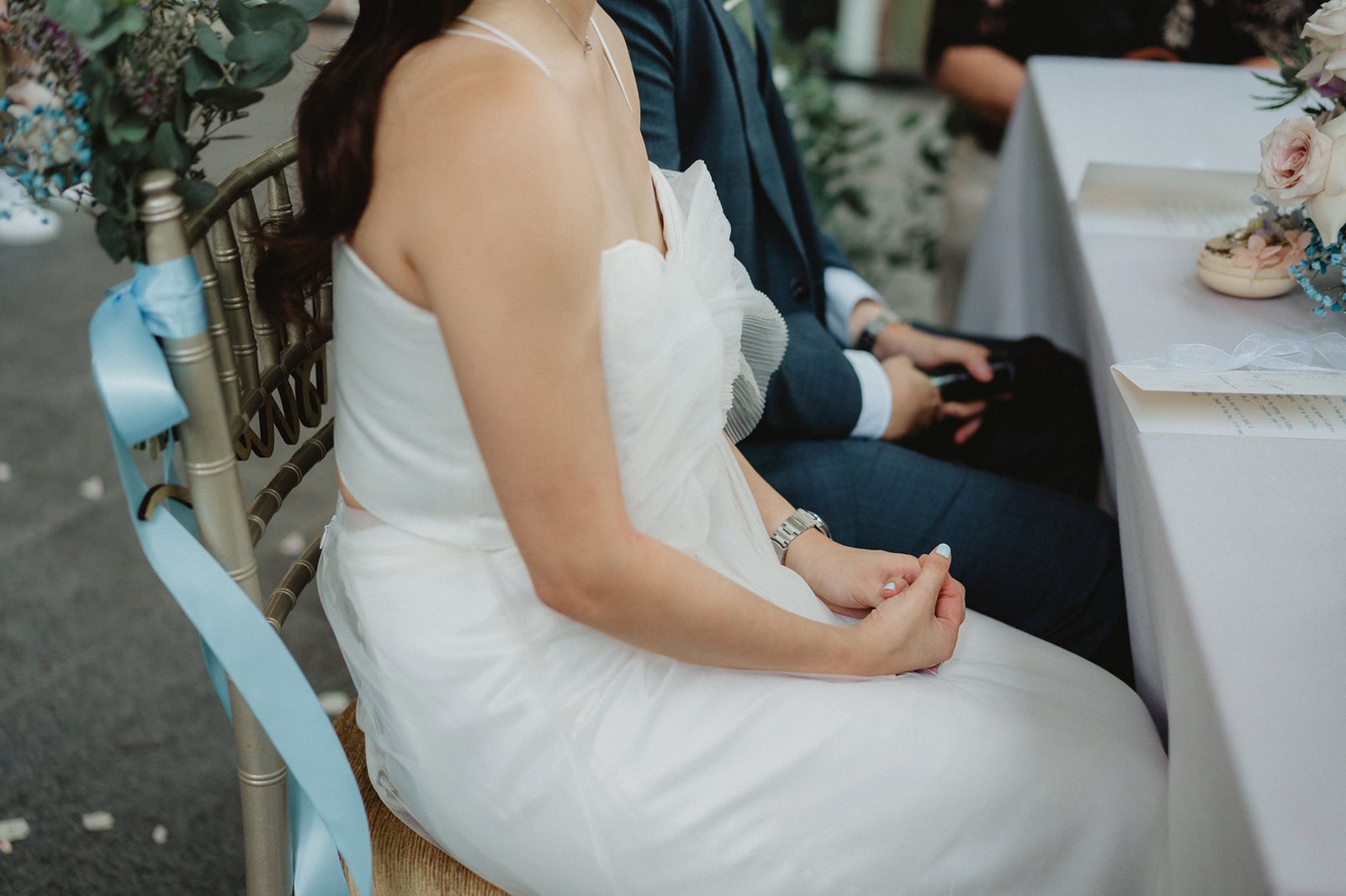 Bride and groom seated at a wedding ceremony at Capella Singapore.