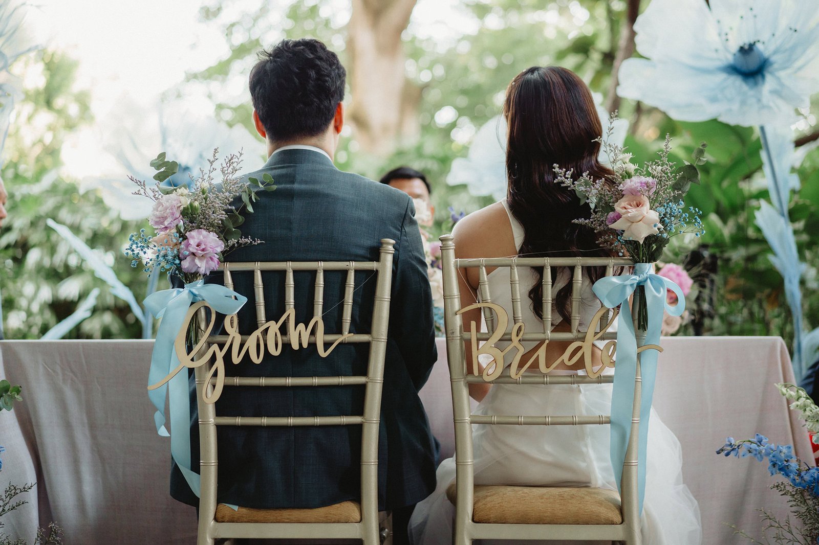 Capella Singapore wedding: Bride and groom chairs with "Bride" and "Groom" signs