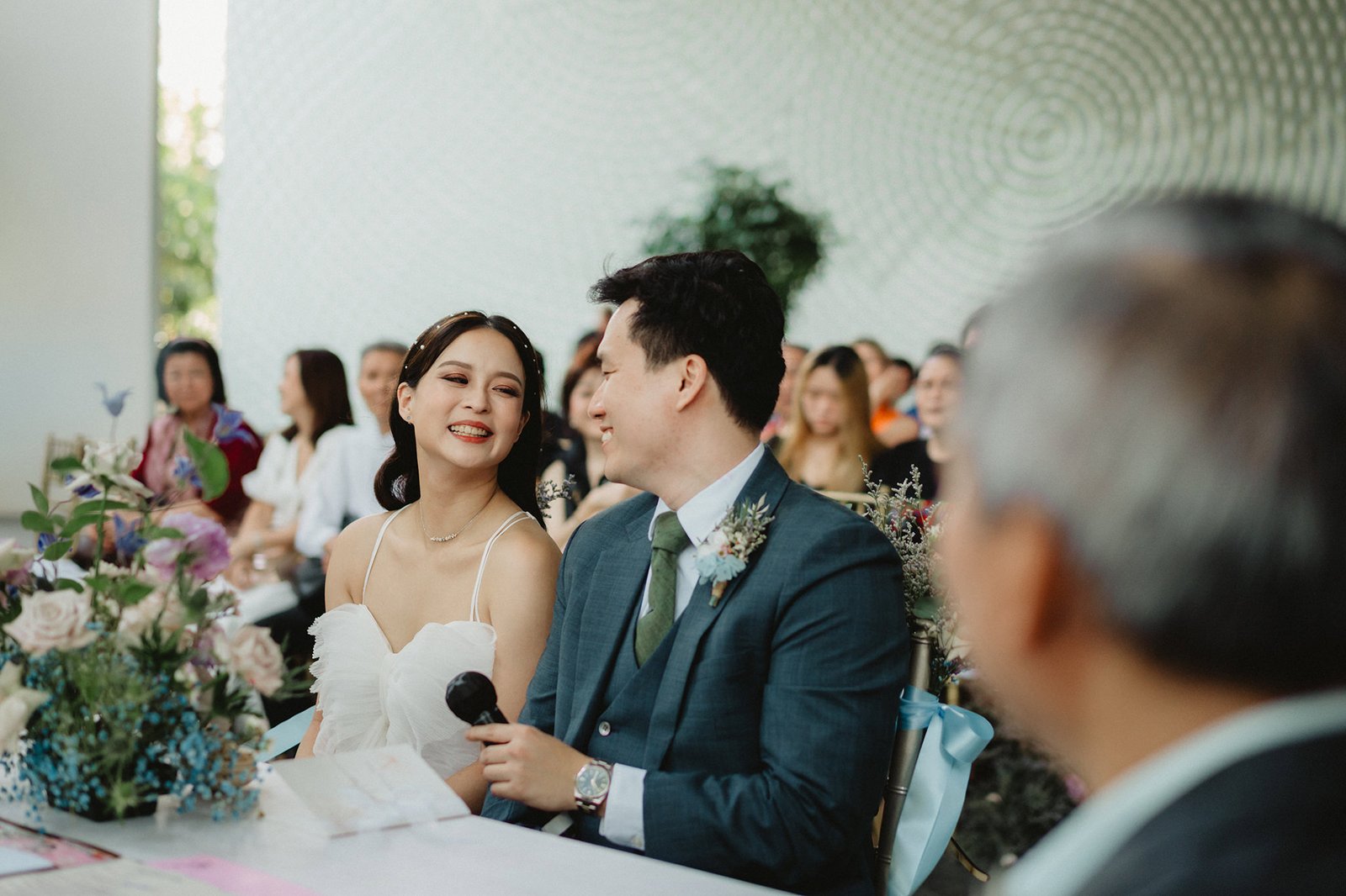 Han and Ming smiling at their Capella Singapore wedding ceremony