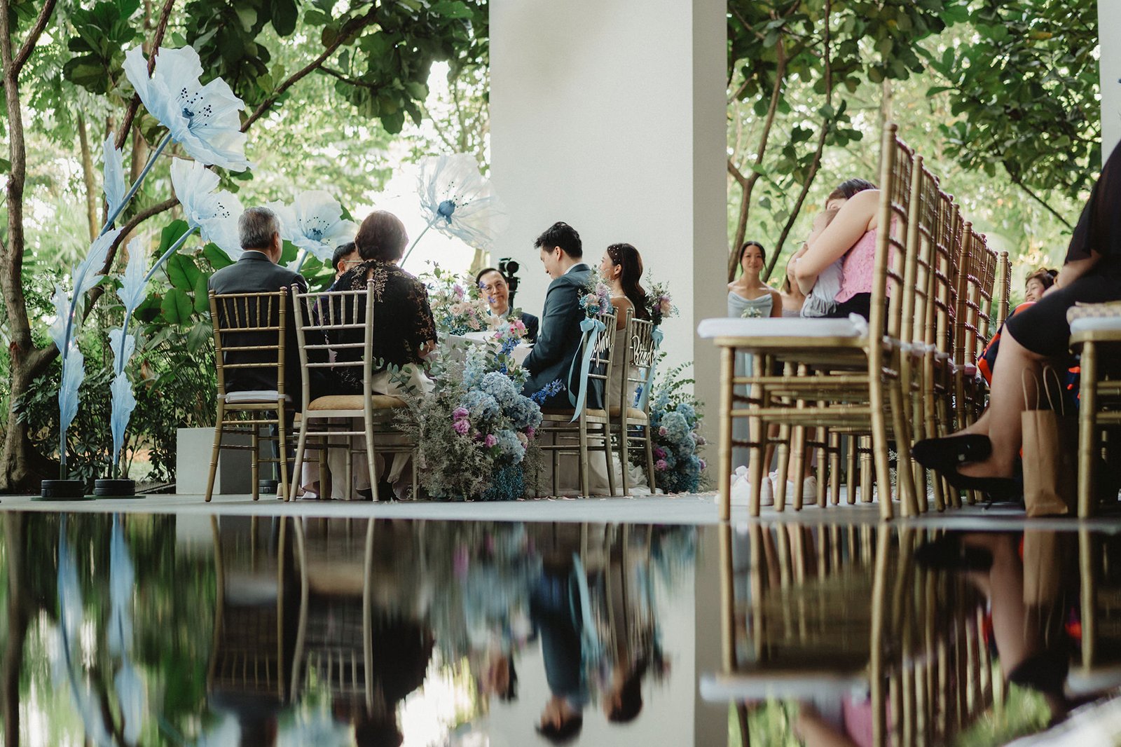 Capella Singapore wedding: couple and guests seated at a reception table
