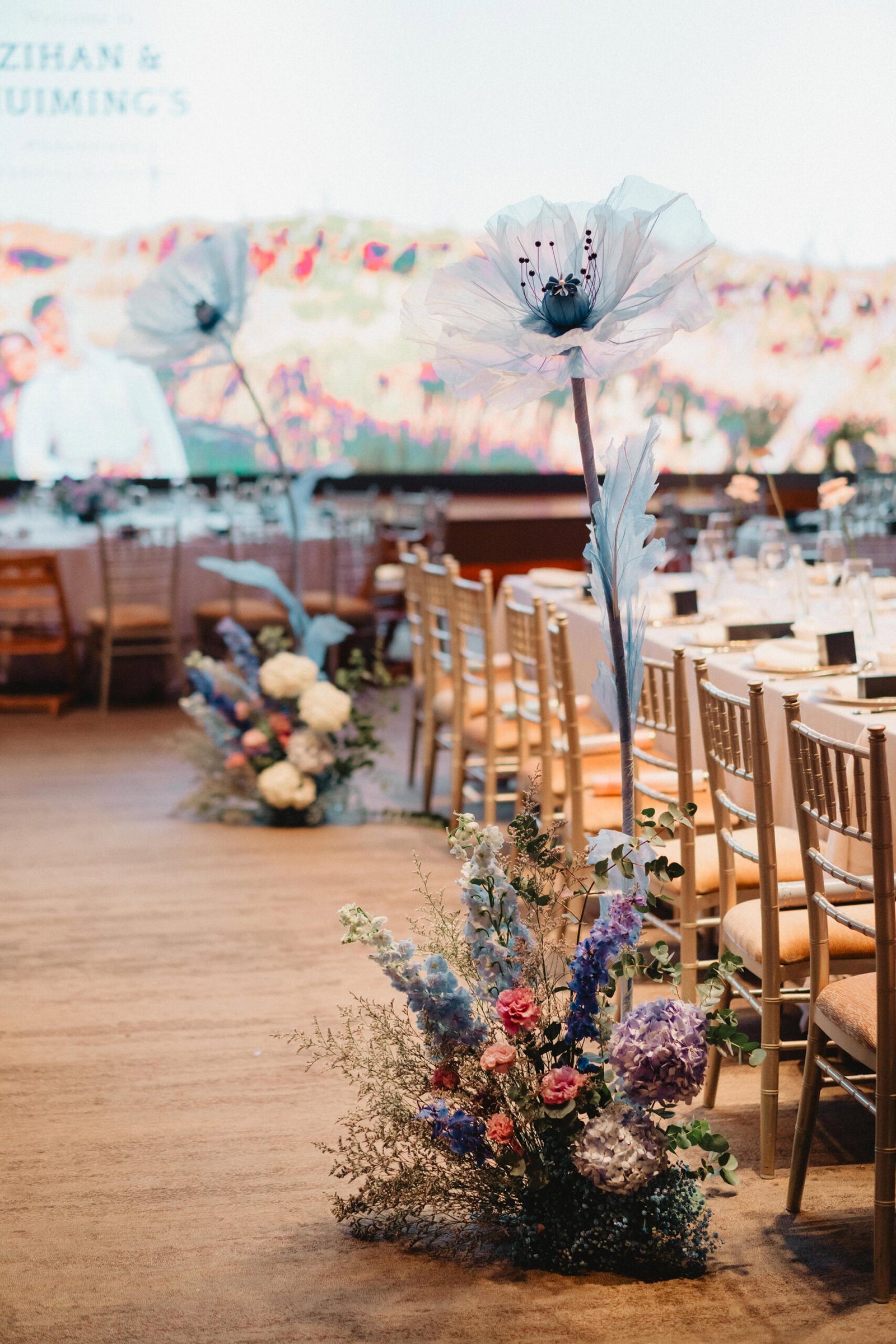 Elegant Capella Singapore wedding decor with large white poppies and floral arrangements.