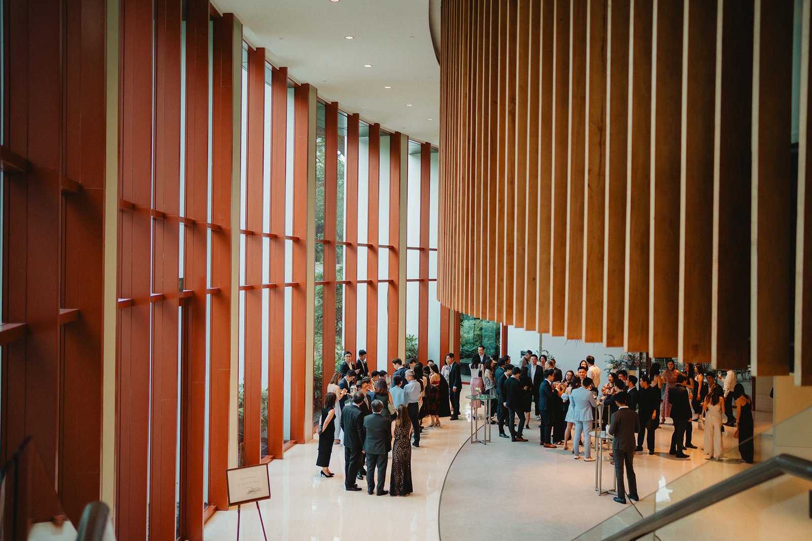 Wedding guests mingle in the grand foyer of Capella Singapore during Han and Ming's celebration.