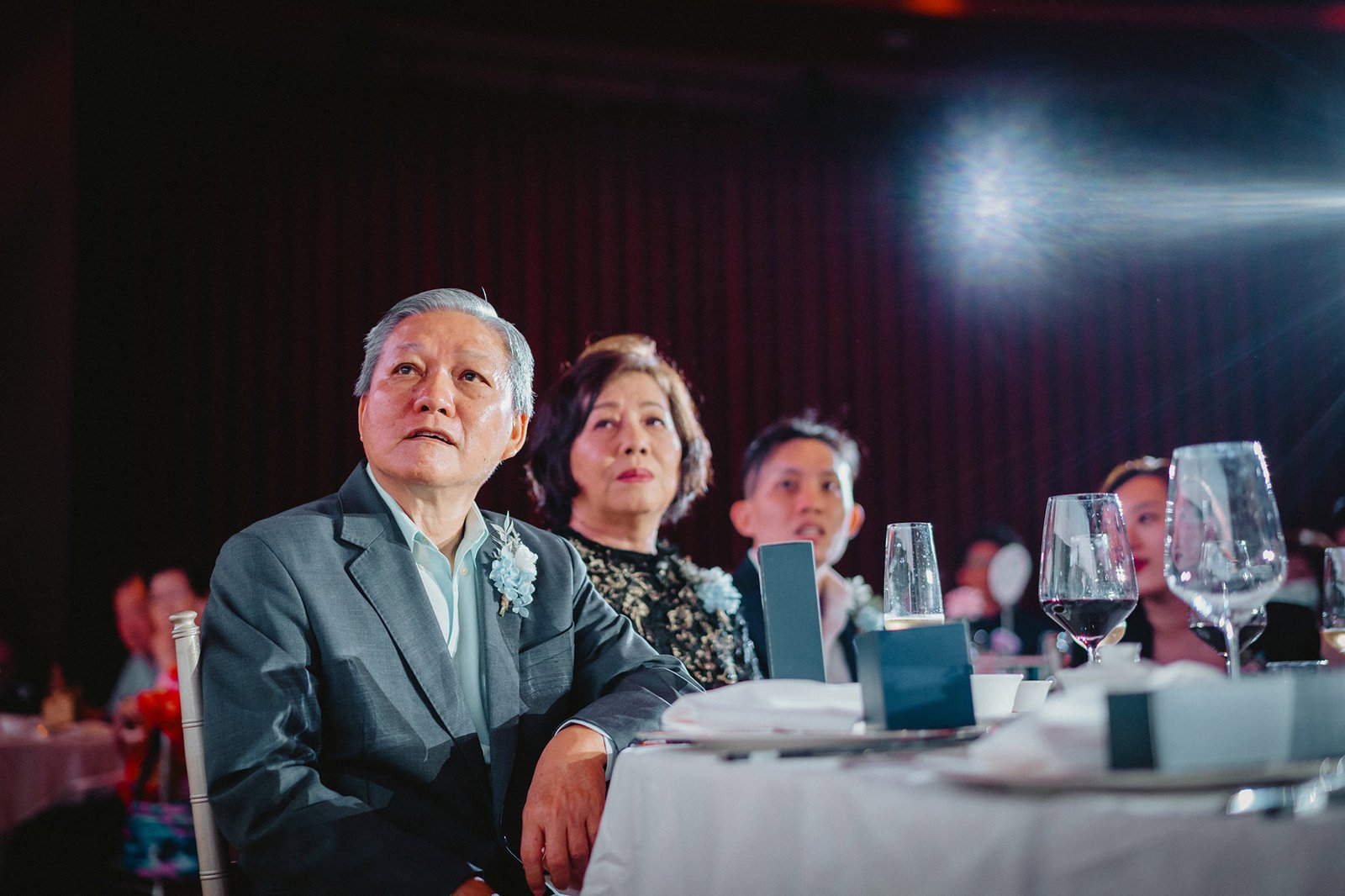 Elderly couple and guests watch a ceremony at Capella Singapore wedding.
