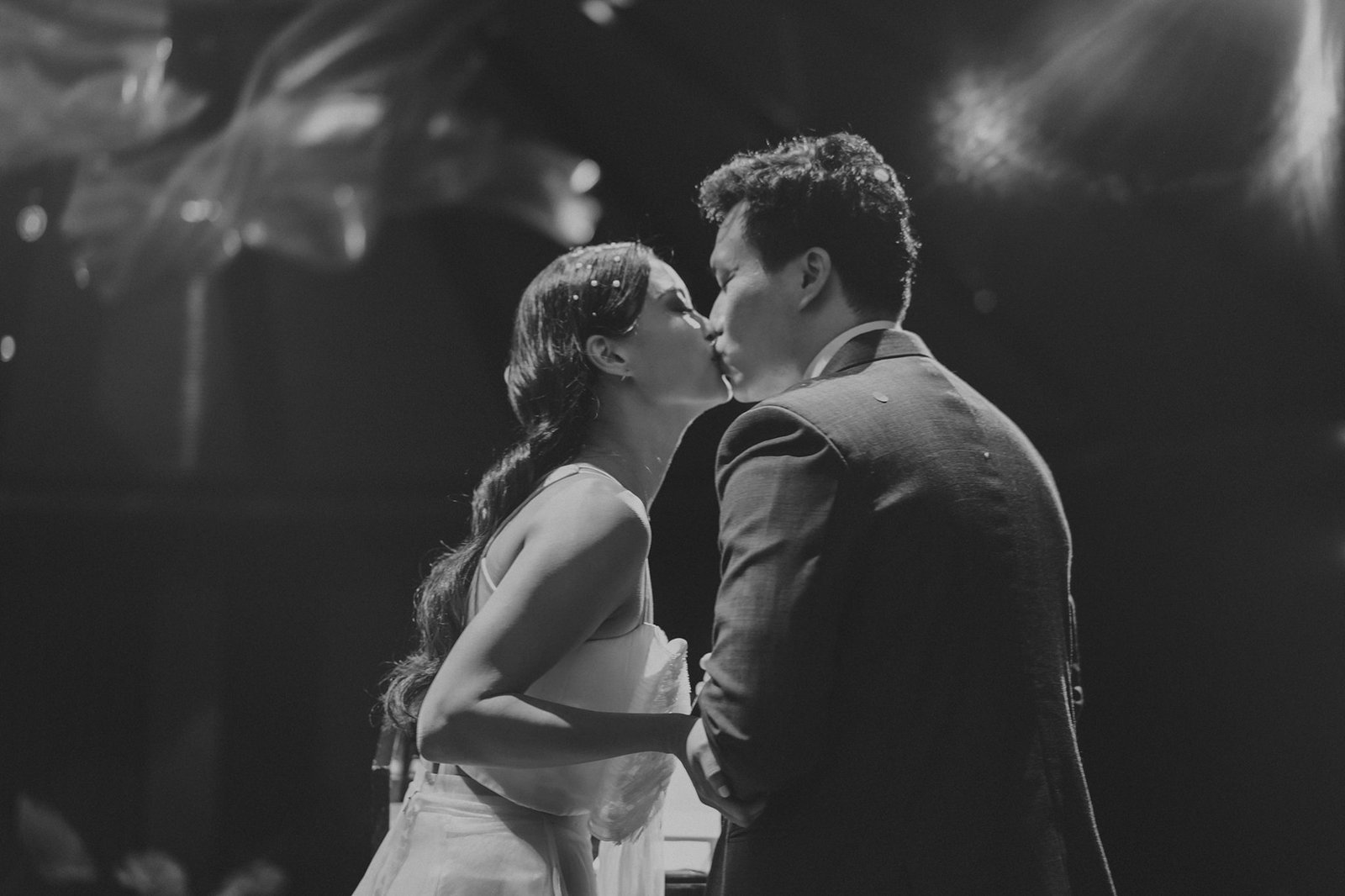 Han and Ming share a tender kiss at their Capella Singapore wedding.
